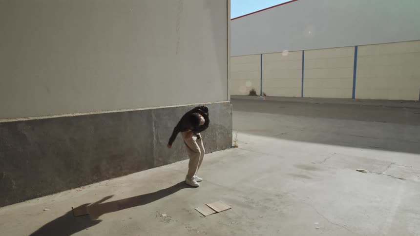 Black man dancing outdoors on a sunny day