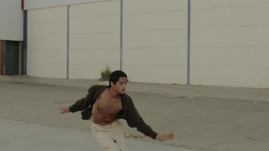 Black boy dancing in a neighborhood