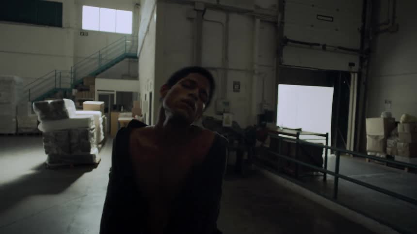 Black boy dancing in a warehouse