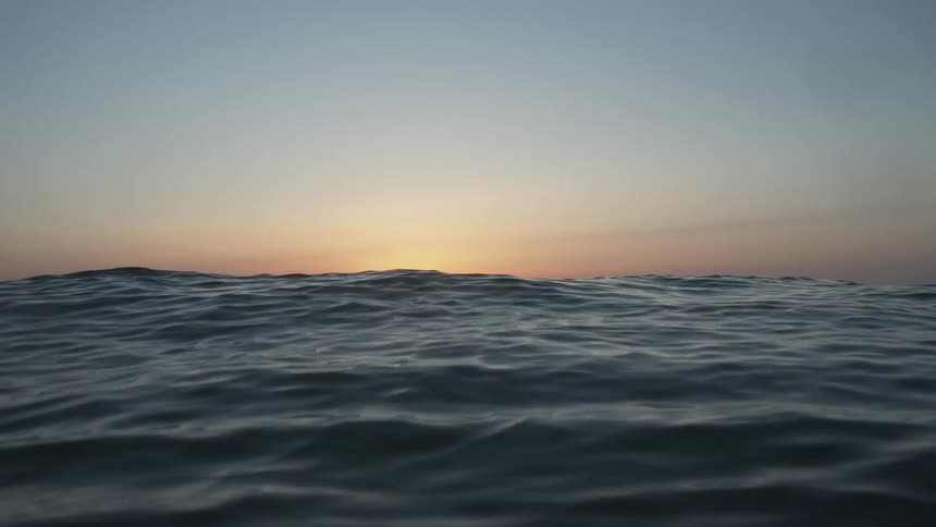 A small wave crossing a calm sea