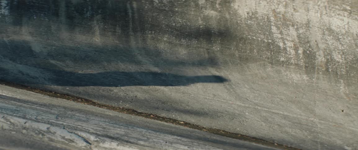 Shadow of a person walking across a rock formation