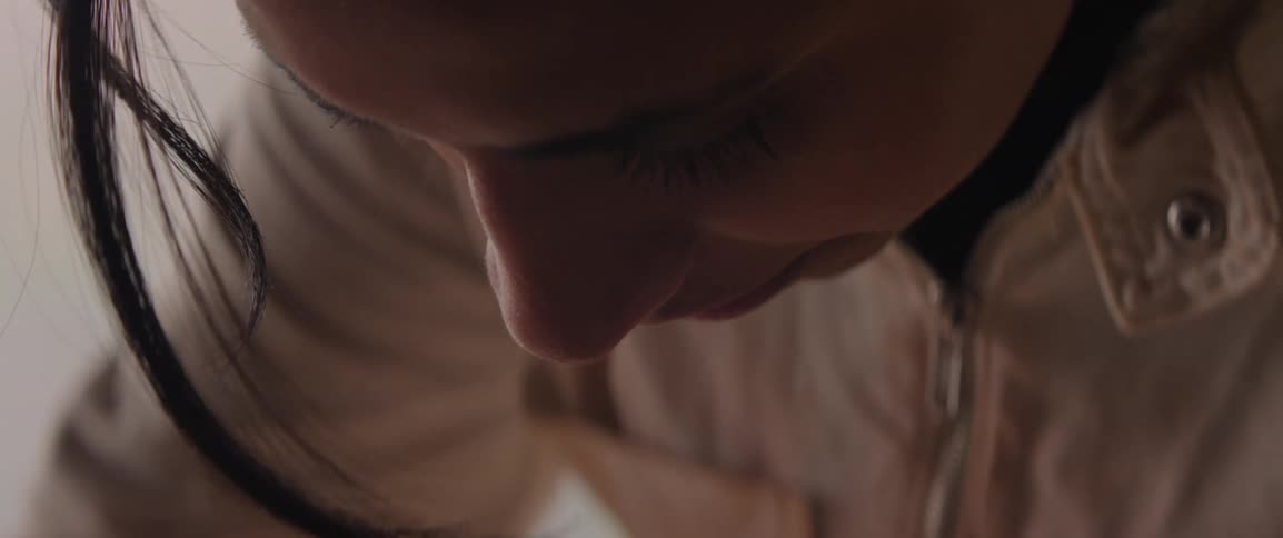 A woman with her head down focused on her work