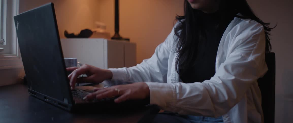 A woman working on her laptop in the office