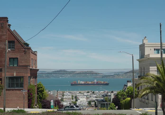 A cargo ship sailing in the sea near the city