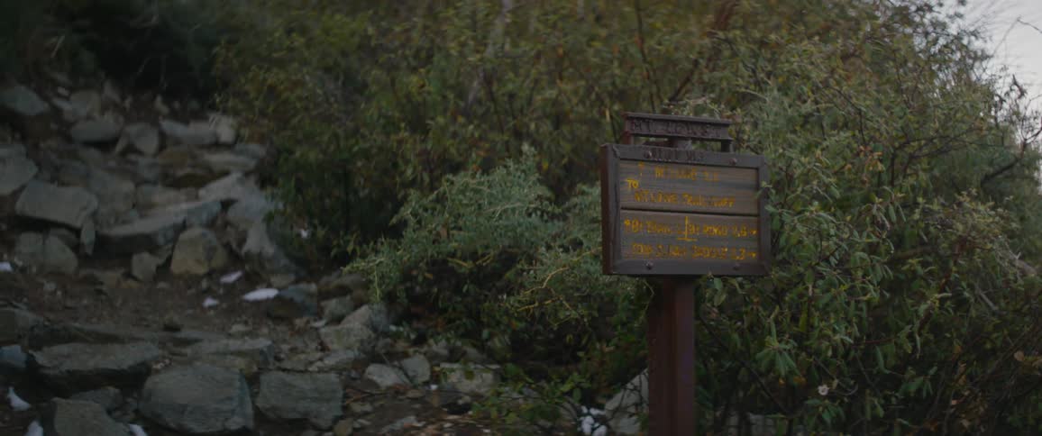 A sign identifying a small clearing covered in rocks on a hill