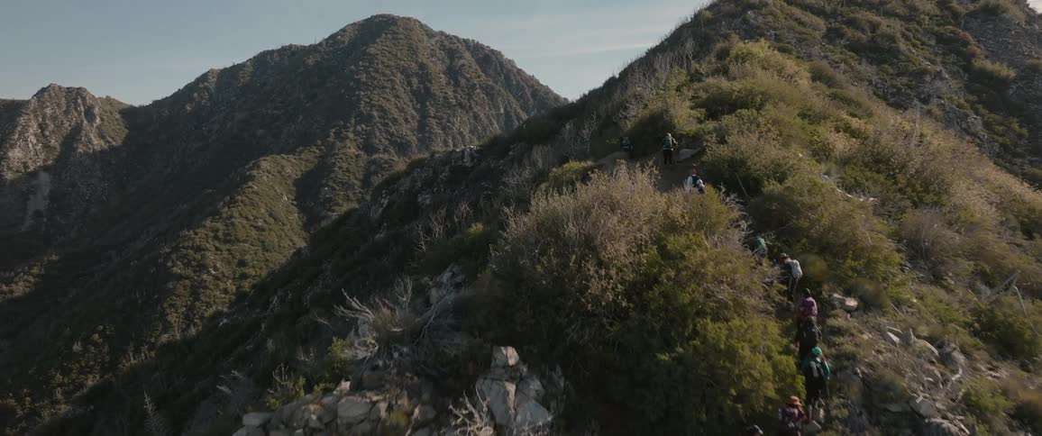 A group of people hiking the mountain