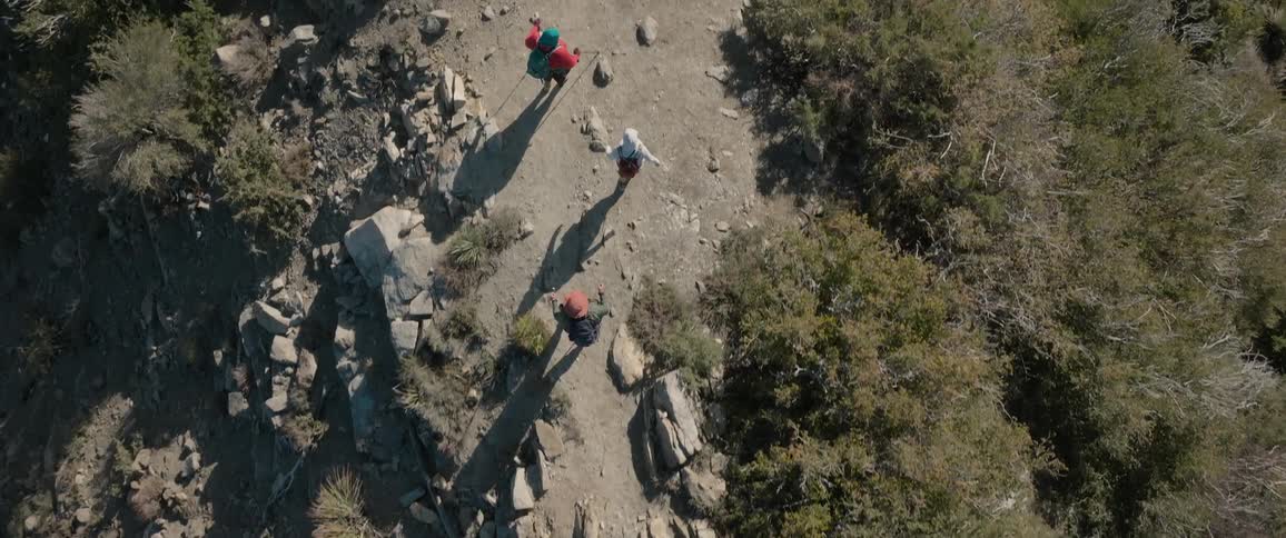 Top view of people walking amid a mountain in daylight
