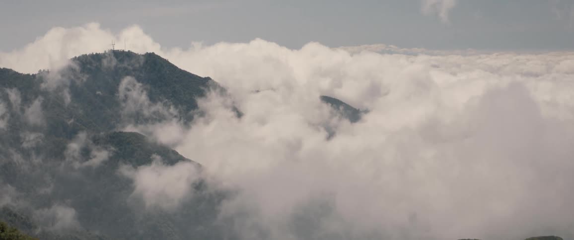 Low lying clouds cover mountainous terrain on a misty day