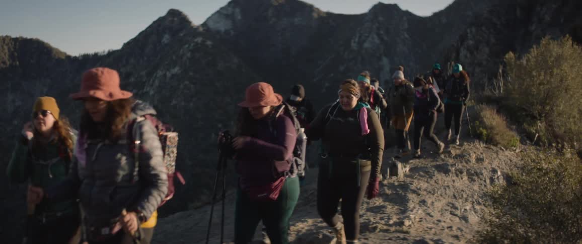 Group of people hiking in the mountains on a morning