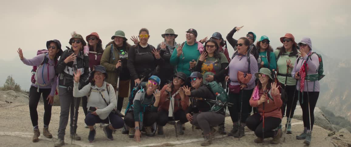 A group pose for a picture on the mountain
