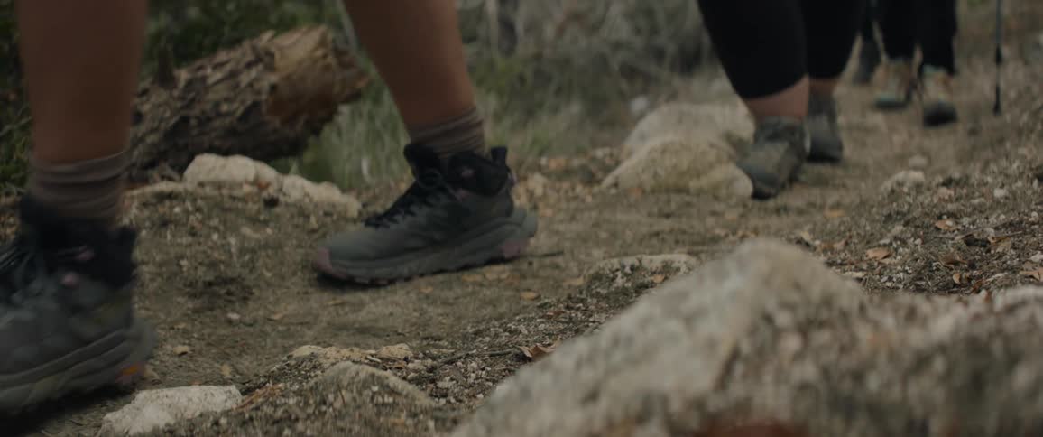 Close up of a group of hikers walking up a dirt trail