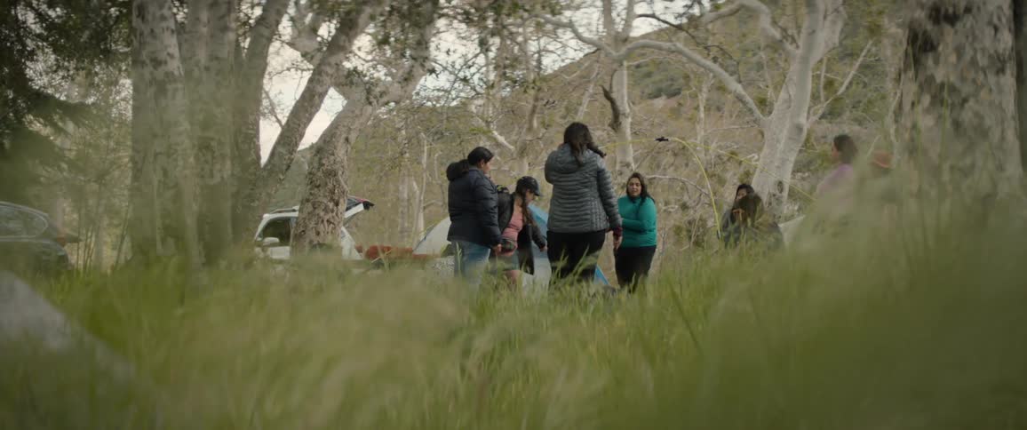 A group of females standing and conversing