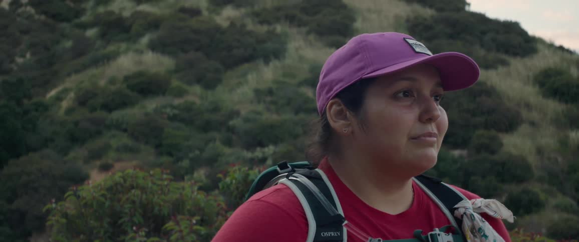 A woman on a hill contemplating the natural landscape