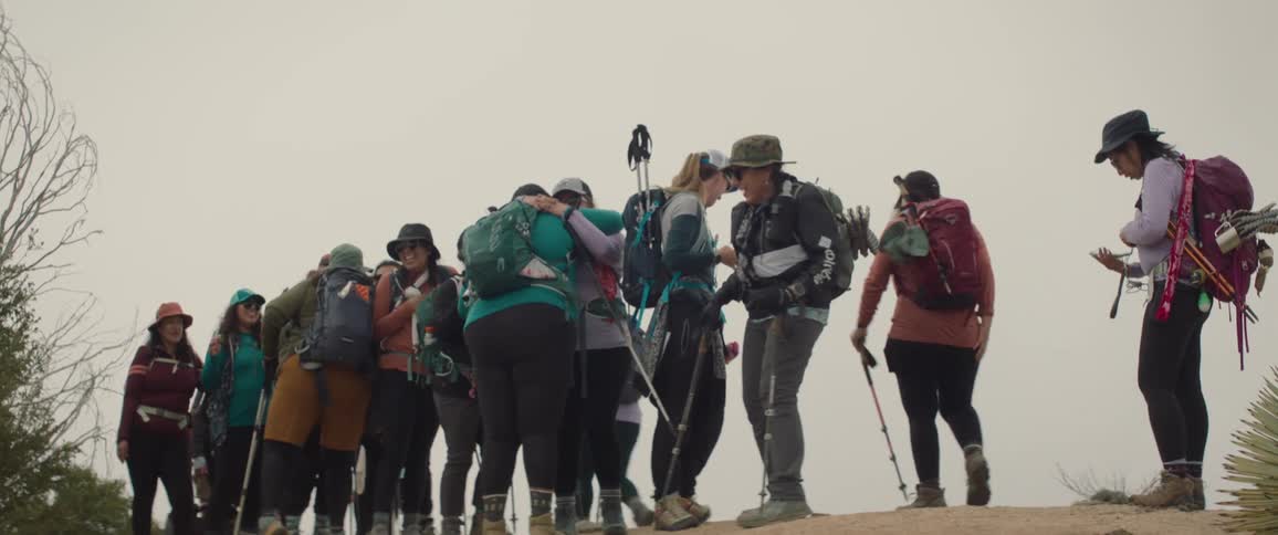 A group of hikers standing and smiling