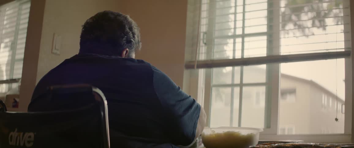 A clip of a person sitting by the window