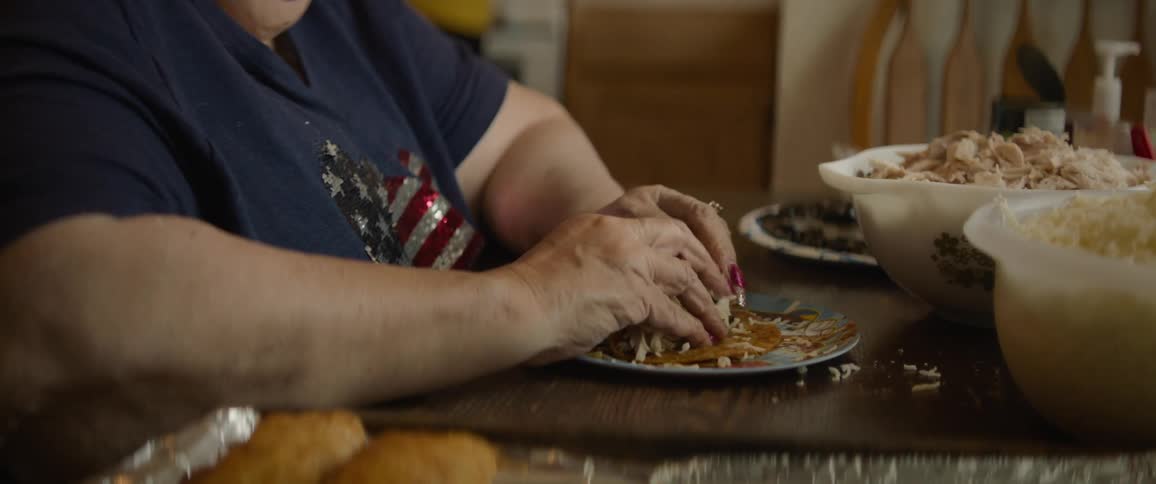 A clip of a person preparing a meal on the dinning table