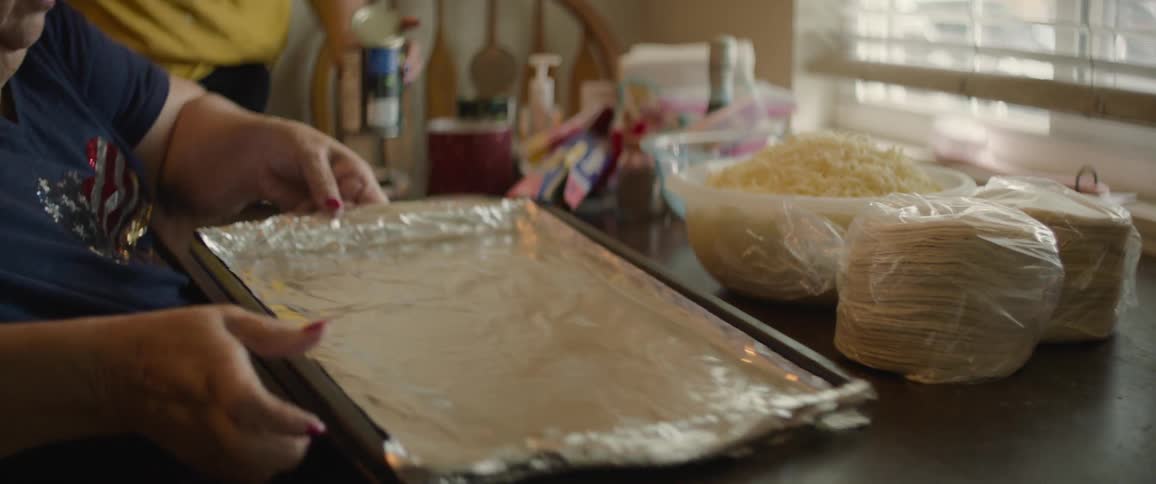 A woman sorting ingredients at the kitchen table