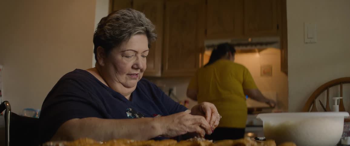 Women prepare a meal in the kitchen during the day