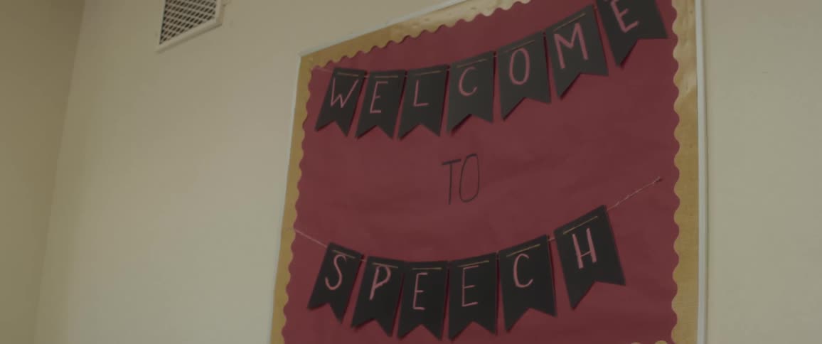 A handcrafted welcome banner hanging on a wall