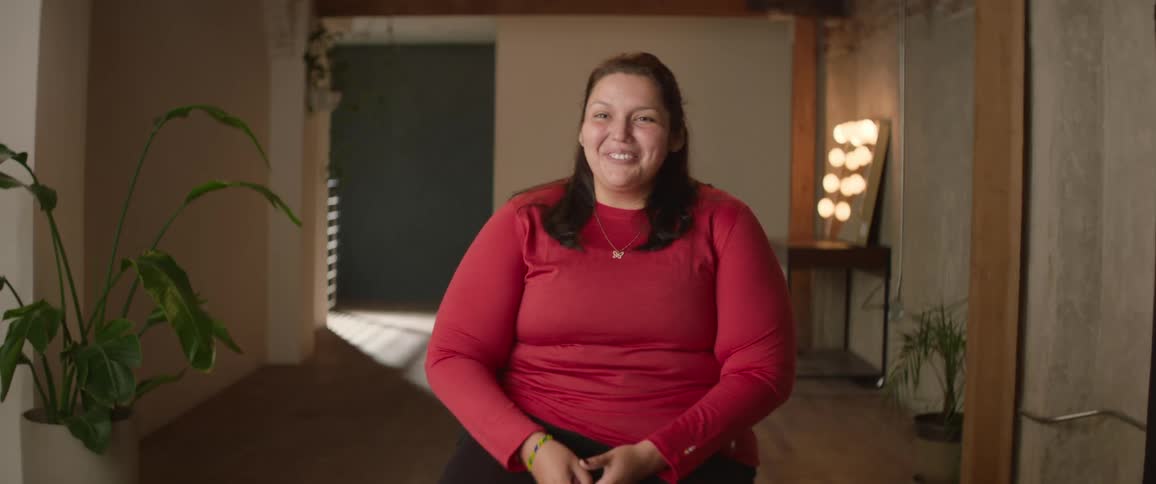 A clip of a lady granting an interview in a room