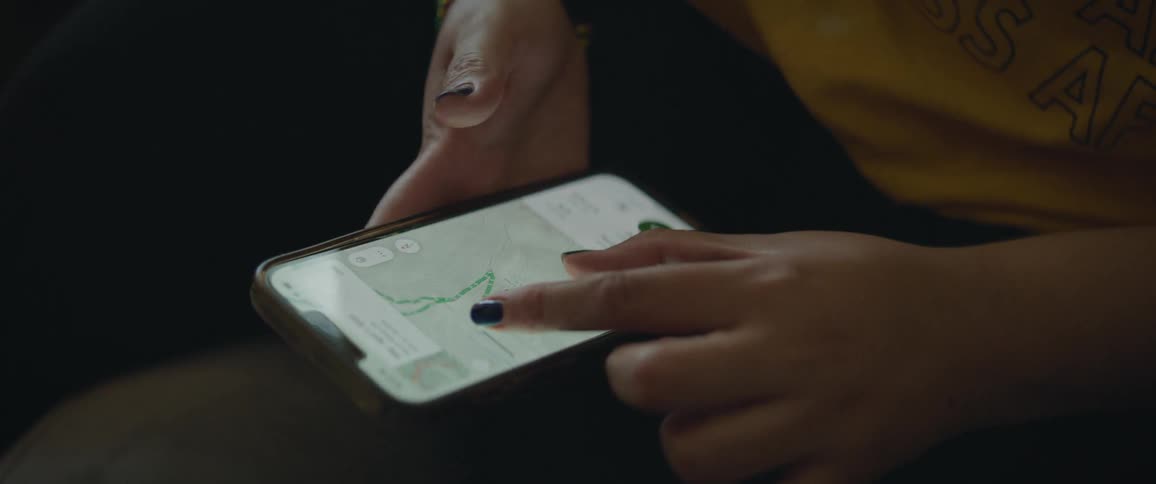 Closeup of a womans hands using her iphone viw maps