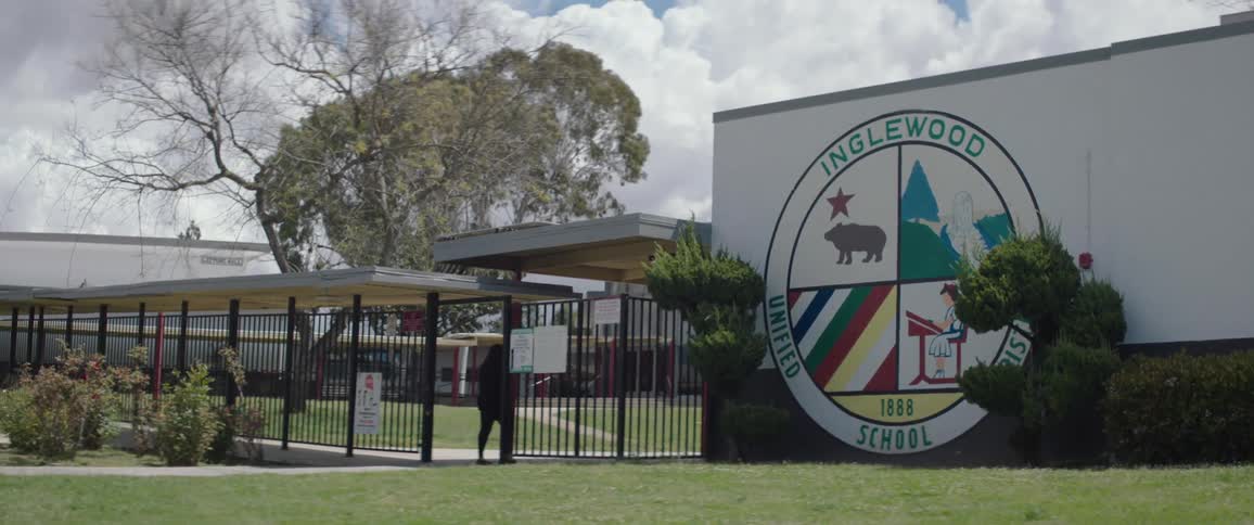 A clip of a person walking into an organizational compound