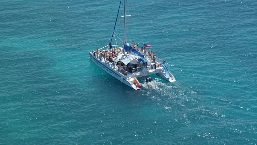 View of people on a yacht moving in the blue sea