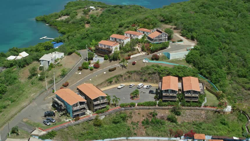 Aerial view of hillside buildings near coastal beach