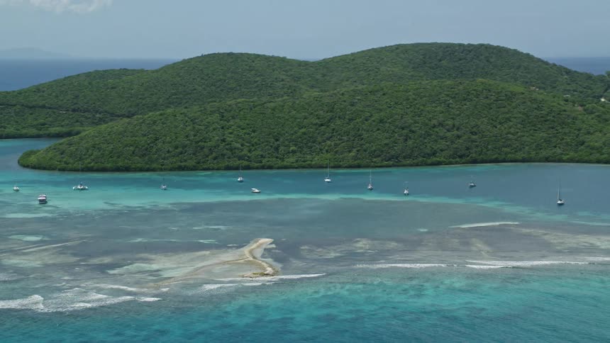 Aerial view of sailboats near the island coast