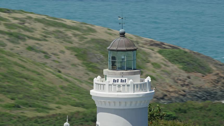 A white lighthouse in a region surrounded by seawater