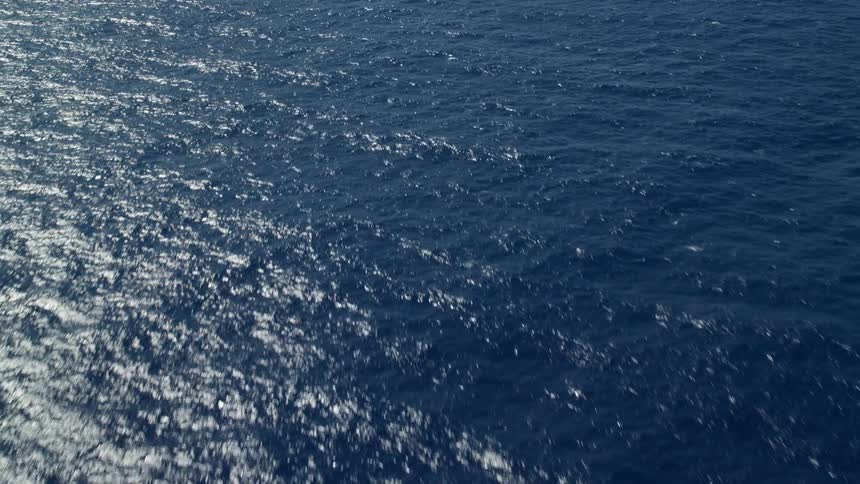 View of the blue sea with the reflection of the sun