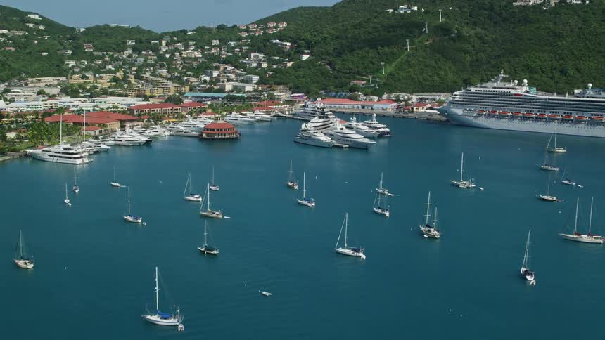 Aerial panorama of yachts and a cruise ship in the sea on a peninsula