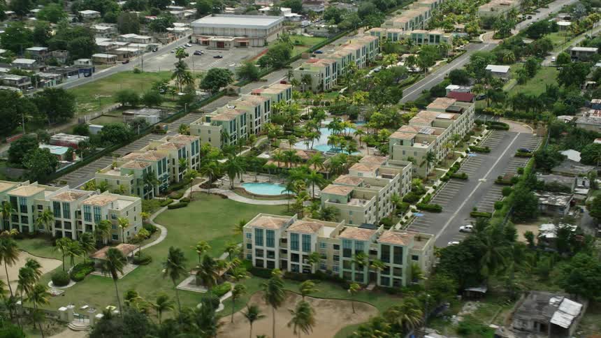 A coastal community near the beach is comprised of houses and apartment buildings