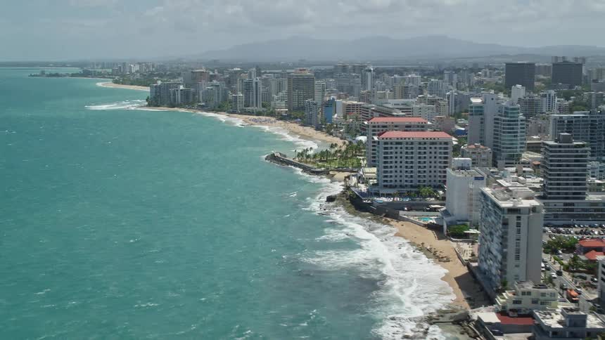 A city with huge buildings in a coastal region surrounded by a sea