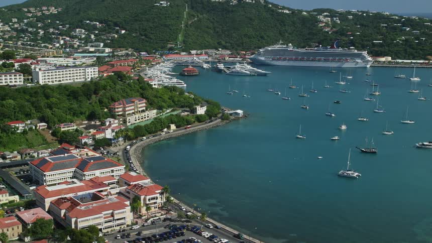 Aerial panorama of an urban city by the beach with yachts and a cruise ship docked