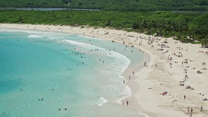 A tropical bay beach with many people