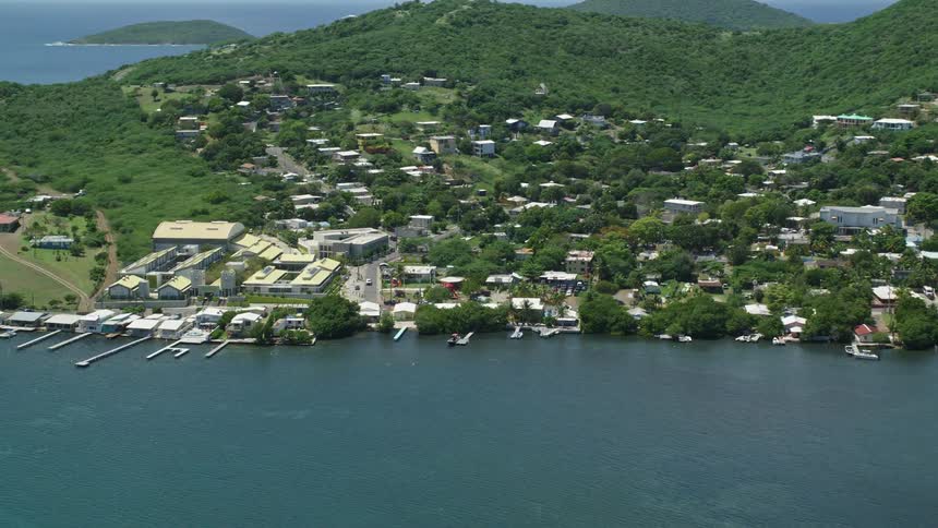 An aerial view of a suburb along the edge of the ocean