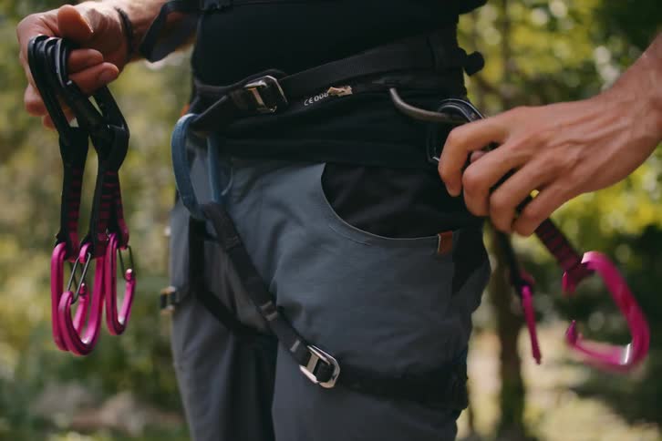 A rock climber hanging carabiners from his belt