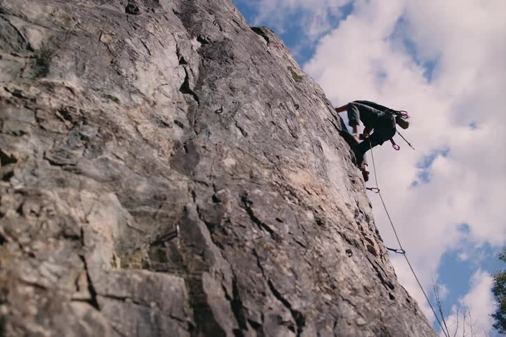 An experienced rock climber climbing a mountain