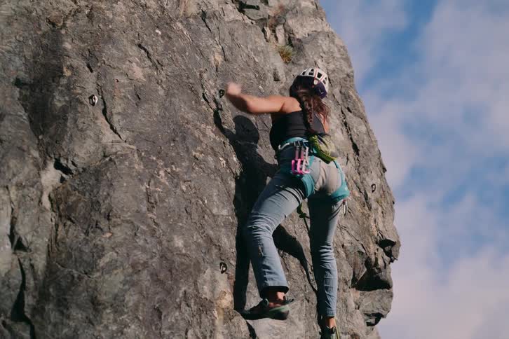 Woman climbing a rocky mountain