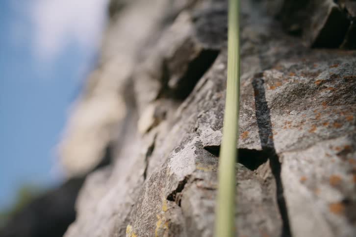 A mountaineers safety rope stretched down a cliff face