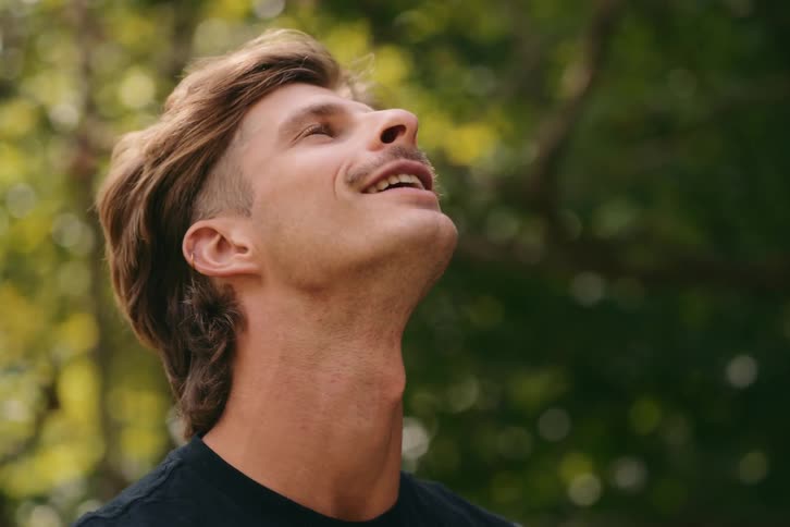 Closeup of a mans face looking at the sky