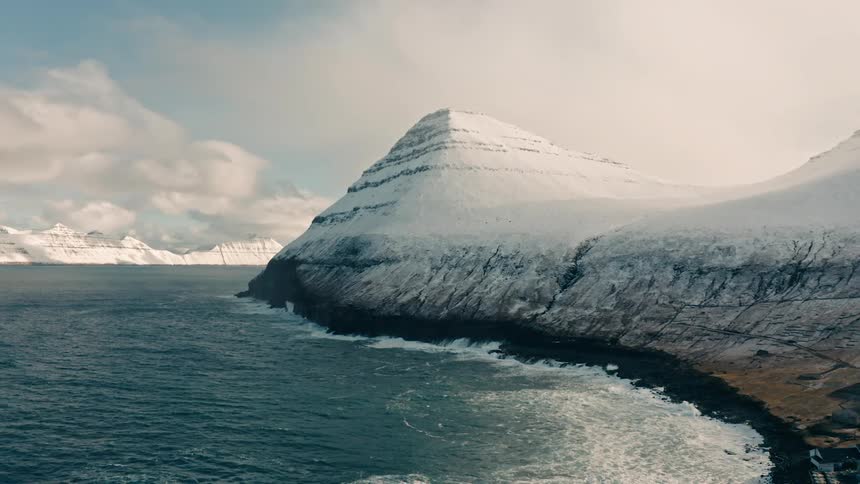 Beach coastline with snow covered mountain