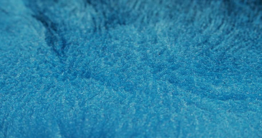 Extreme closeup of a shining blue fluid