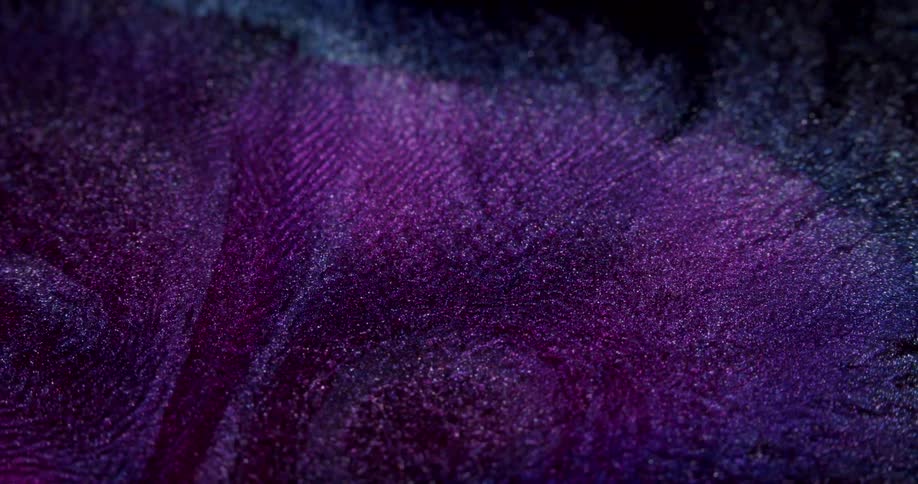 Pink and abstract glow expanding in a dark fluid in slow motion