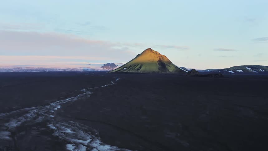 Aerial of a volcanic mountain and a small river in the landscape