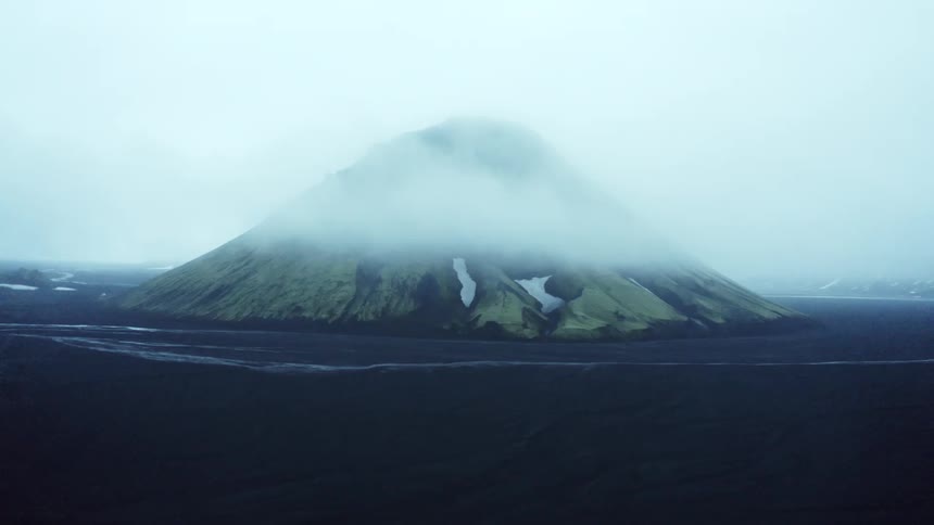 A clip of a misty hill in the sea