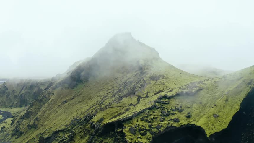 A clip of a foggy grass mountain