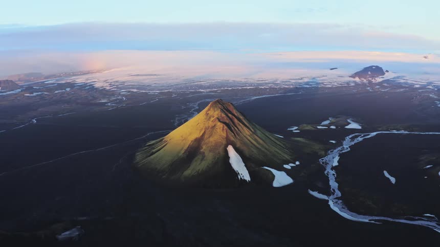 Aerial of a mountain during cloudy dawn