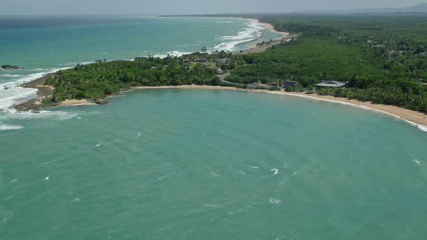 Aerial panorama of a city amidst an island with beaches featuring crystalclear waters